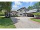 Beautiful two-story home with large driveway, three-car garage, and well-maintained lawn at 14121 Bella Ln, Orlando, FL 32832