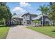 Stately two-story home with a three-car garage and a curved paver driveway at 14121 Bella Ln, Orlando, FL 32832