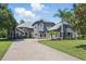 Stately two-story home with a three-car garage and a curved paver driveway at 14121 Bella Ln, Orlando, FL 32832