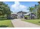 Stunning two-story home boasts lush landscaping and a paver driveway at 14121 Bella Ln, Orlando, FL 32832