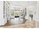 Bright living room with custom built-in bookshelves, wood floors, and access to other living areas at 14121 Bella Ln, Orlando, FL 32832