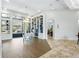 Spacious living room with custom bookshelves, access to outdoor area, and open to dining room at 14121 Bella Ln, Orlando, FL 32832