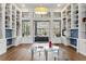 Living room with custom bookshelves, glass doors and access to backyard at 14121 Bella Ln, Orlando, FL 32832