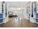 Bright living room with custom built-in bookshelves and view into the dining room at 14121 Bella Ln, Orlando, FL 32832