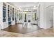 Bright living room with custom built-in bookshelves, wood floors, and glass doors to the outdoor area at 14121 Bella Ln, Orlando, FL 32832