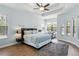 Inviting main bedroom with a tray ceiling, lots of natural light, and a cozy seating area at 14121 Bella Ln, Orlando, FL 32832