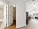 A view of the hallway, the office, and the bathroom featuring a tub and toilet combo at 14121 Bella Ln, Orlando, FL 32832
