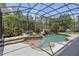 Screened-in pool and spa with waterfall feature and lush landscaping at 14121 Bella Ln, Orlando, FL 32832