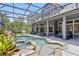 Screened-in pool and spa with waterfall feature, next to the house at 14121 Bella Ln, Orlando, FL 32832