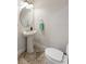 Clean powder room with pedestal sink, oval mirror, tiled floors, and light blue hand towel on ring at 14121 Bella Ln, Orlando, FL 32832