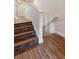 Hardwood stairs feature white railings leading to the upper levels of the house at 14121 Bella Ln, Orlando, FL 32832