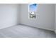Spacious bedroom with gray carpeting and a large window at 1634 Sugarbelle Cir, Mascotte, FL 34753