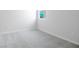 Simple bedroom with gray carpeting and neutral walls at 1634 Sugarbelle Cir, Mascotte, FL 34753
