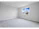 Bright bedroom with carpeted floor and large window at 1634 Sugarbelle Cir, Mascotte, FL 34753