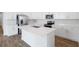 Modern kitchen with white cabinets, stainless steel appliances, and a large island at 1634 Sugarbelle Cir, Mascotte, FL 34753
