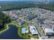 Community aerial view showcasing a pool, walking trails, and numerous homes situated amongst green spaces and a lake at 1862 Beach Ridge Rd, Celebration, FL 34747