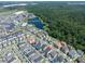 Aerial view of a lovely home near a peaceful lake, surrounded by lush trees at 1862 Beach Ridge Rd, Celebration, FL 34747