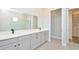 Bathroom featuring a dual sink vanity, glass-enclosed shower, tile flooring, and a walk-in closet at 1862 Beach Ridge Rd, Celebration, FL 34747