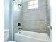 Bathroom featuring stylish tiling surrounding the tub and shower with updated fixtures at 1862 Beach Ridge Rd, Celebration, FL 34747