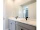 Bathroom featuring double sink vanity with a white countertop and grey cabinets at 1862 Beach Ridge Rd, Celebration, FL 34747