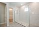 Bathroom featuring a glass-door shower and a doorway leading to a walk-in closet with shelving at 1862 Beach Ridge Rd, Celebration, FL 34747