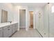 Bathroom featuring a glass-door shower, walk-in closet, gray vanity, and tile flooring at 1862 Beach Ridge Rd, Celebration, FL 34747