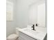 Well-lit bathroom with a modern vanity, matte black faucet, and white quartz countertop at 1862 Beach Ridge Rd, Celebration, FL 34747