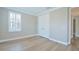 Well-lit, neutral bedroom with hardwood floors, window with shutters, and a closet at 1862 Beach Ridge Rd, Celebration, FL 34747