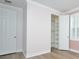 This bedroom features an organizational closet, shuttered window, and wood-look floors at 1862 Beach Ridge Rd, Celebration, FL 34747