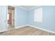 Bedroom featuring bright white trim, shuttered windows, and wood-look flooring at 1862 Beach Ridge Rd, Celebration, FL 34747
