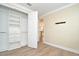 Bedroom featuring light colored walls, closet system, and light, wood-look flooring at 1862 Beach Ridge Rd, Celebration, FL 34747