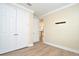 Bedroom featuring light walls, bright white trim, and closet with bi-fold doors at 1862 Beach Ridge Rd, Celebration, FL 34747