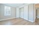 This airy bedroom contains hardwood floors, shutters, an open closet, and connecting hallway at 1862 Beach Ridge Rd, Celebration, FL 34747