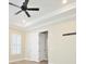 This bedroom includes neutral walls, a fan, a window with shutters, and a connecting door at 1862 Beach Ridge Rd, Celebration, FL 34747