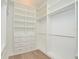 Custom closet features built-in shelves, drawers, and hanging rods, maximizing storage and organization at 1862 Beach Ridge Rd, Celebration, FL 34747