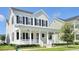 Charming two-story home features a welcoming front porch with columns and landscaped front yard at 1862 Beach Ridge Rd, Celebration, FL 34747