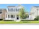 Beautiful two-story home with a wide front porch, black shutters, and a well-manicured lawn at 1862 Beach Ridge Rd, Celebration, FL 34747