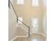 Bright entryway featuring a staircase, high ceilings, and elegant flooring that leads into the home at 1862 Beach Ridge Rd, Celebration, FL 34747