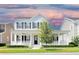 Charming two-story home with a welcoming front porch, complemented by a beautifully landscaped front yard at 1862 Beach Ridge Rd, Celebration, FL 34747