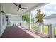 A cozy front porch features brick flooring, a ceiling fan, and white railings at 1862 Beach Ridge Rd, Celebration, FL 34747