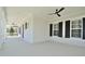 Inviting covered porch with ceiling fans and classic white columns, offering a relaxing outdoor space at 1862 Beach Ridge Rd, Celebration, FL 34747