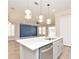 Open-concept kitchen featuring stainless steel appliances, a sink, a quartz countertop, and pendant lighting at 1862 Beach Ridge Rd, Celebration, FL 34747