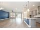 Open-concept kitchen featuring stainless steel appliances, a sink, a quartz countertop, and pendant lighting at 1862 Beach Ridge Rd, Celebration, FL 34747
