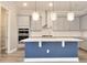 Kitchen with quartz countertops, stainless steel appliances, a center island and neutral tone cabinets at 1862 Beach Ridge Rd, Celebration, FL 34747