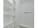A clean and organized walk-in closet has built-in shelves and drawers at 1862 Beach Ridge Rd, Celebration, FL 34747