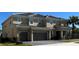 Beautiful tan two-story home with a two-car garage, a tiled roof, a driveway, and a palm tree at 3801 Sonoma Blvd, Kissimmee, FL 34741