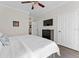 Comfortable bedroom featuring a ceiling fan, dresser with television, and a large closet at 1370 Tuscan Ter # 2104, Davenport, FL 33896