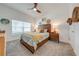 Bright bedroom with a wooden bed frame and neutral tones at 4222 Paragraph Dr, Kissimmee, FL 34746