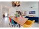 Open concept dining room with wood table and colorful chairs at 4222 Paragraph Dr, Kissimmee, FL 34746