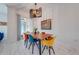 Bright dining area with a wood table and colorful mid-century modern chairs at 4222 Paragraph Dr, Kissimmee, FL 34746